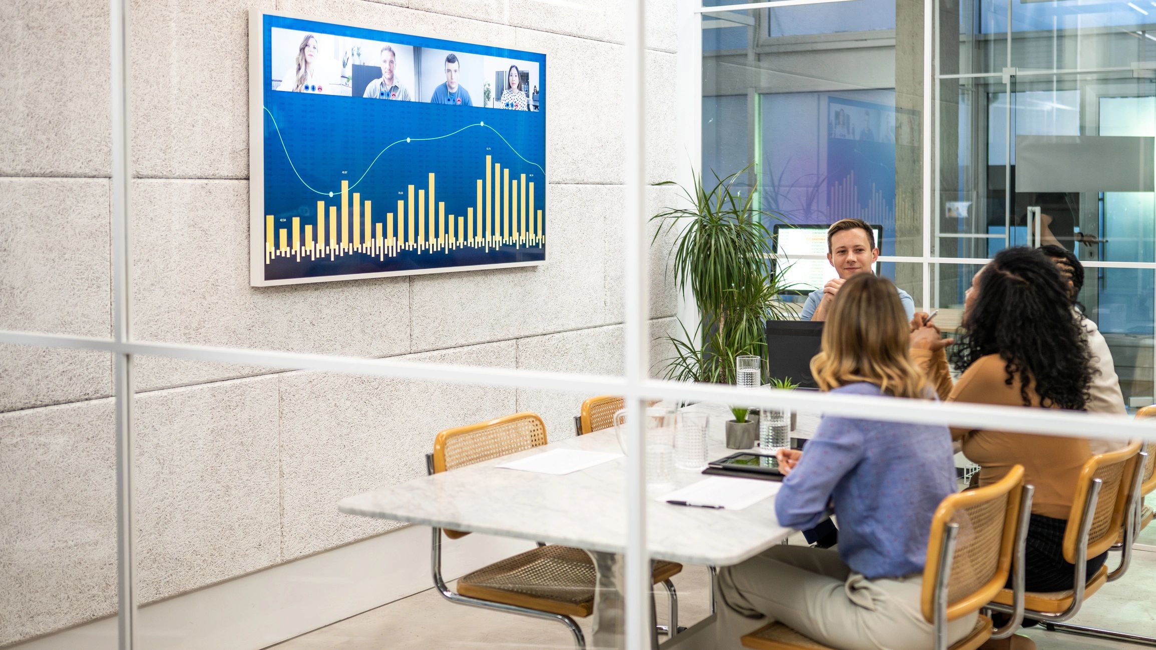 Team collaborating around digital screens in a modern operations environment